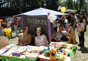 Panie nauczycielki siedzą przy loterii fantowej