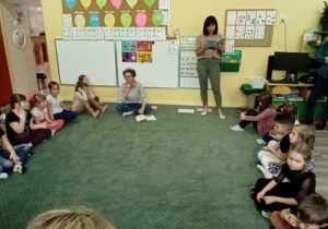 Dzieci słuchają opowiadania czytanego przez ciocię Klaudię