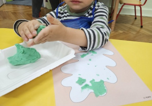 Artur wykleja listek.