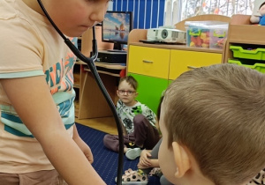 Julian bada Jasia stetoskopem.