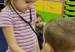 Julia bada Jasia stetoskopem.