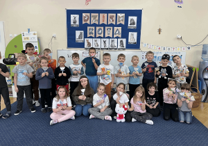 Grupowe zdjęcie z wykonanymi przez dzieci pracami plastycznymi.