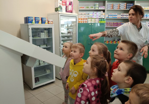 Robot przekazuje lek na pas transportowy.